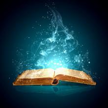 open book lying flat with blue light and sparks coming out of it