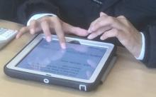 Close up of a school iPad with learners hands
